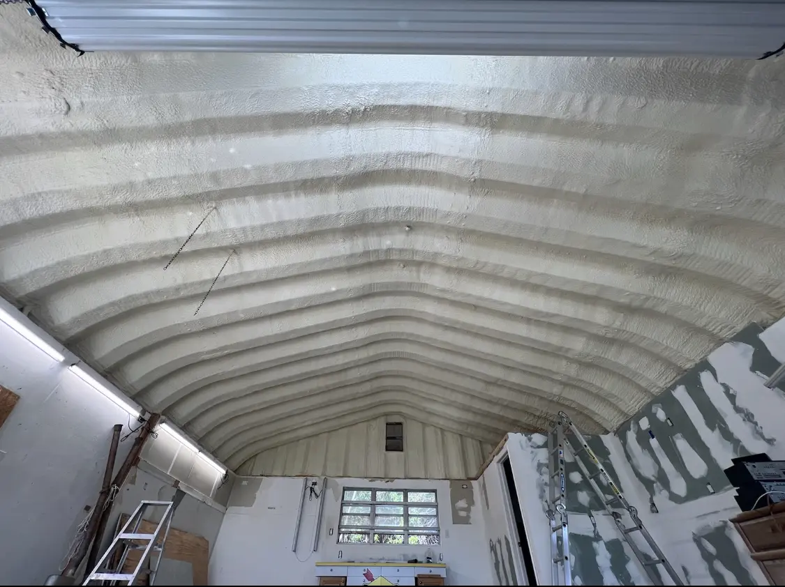 Spray polyurethane foam applied to the underside of a metal roof deck in Indiana